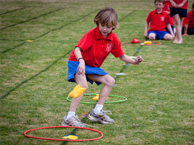 kids in bean bag race at school sports day